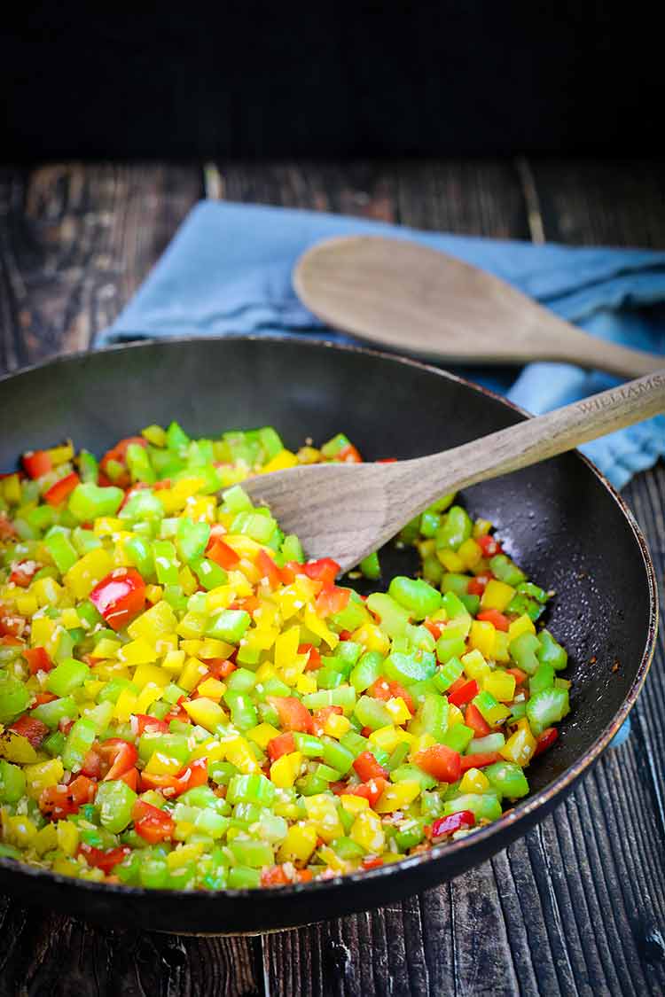 Onions, peppers, jalapeños, peppers and celery sauteing