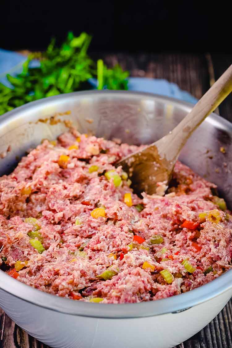 ground beef mixed with vegetables in a boal