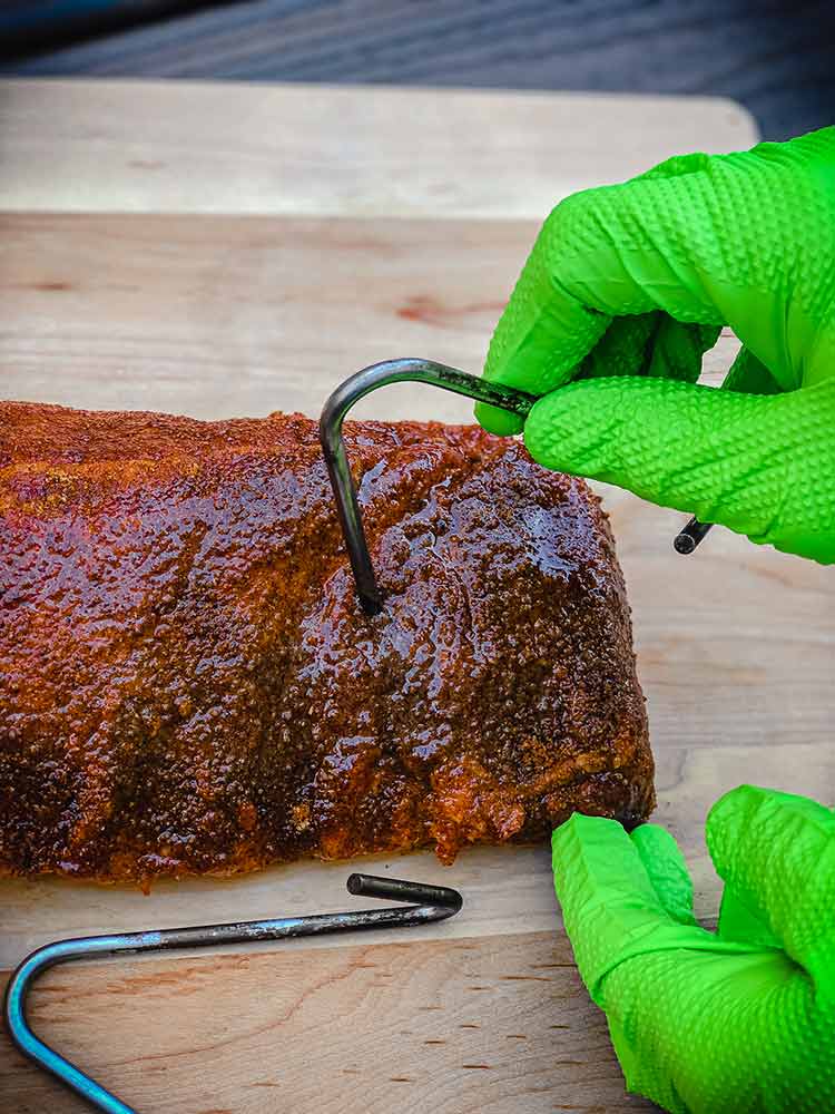 placing the first hook about two bones deep in the ribs