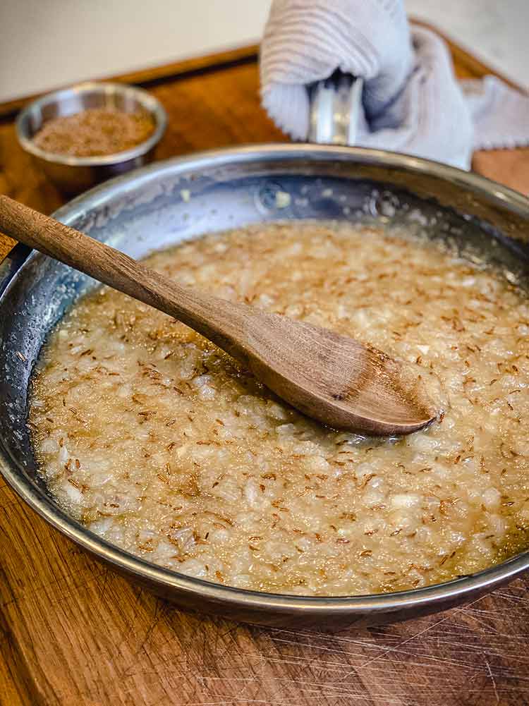 wooden spoon stirring mixture in pan