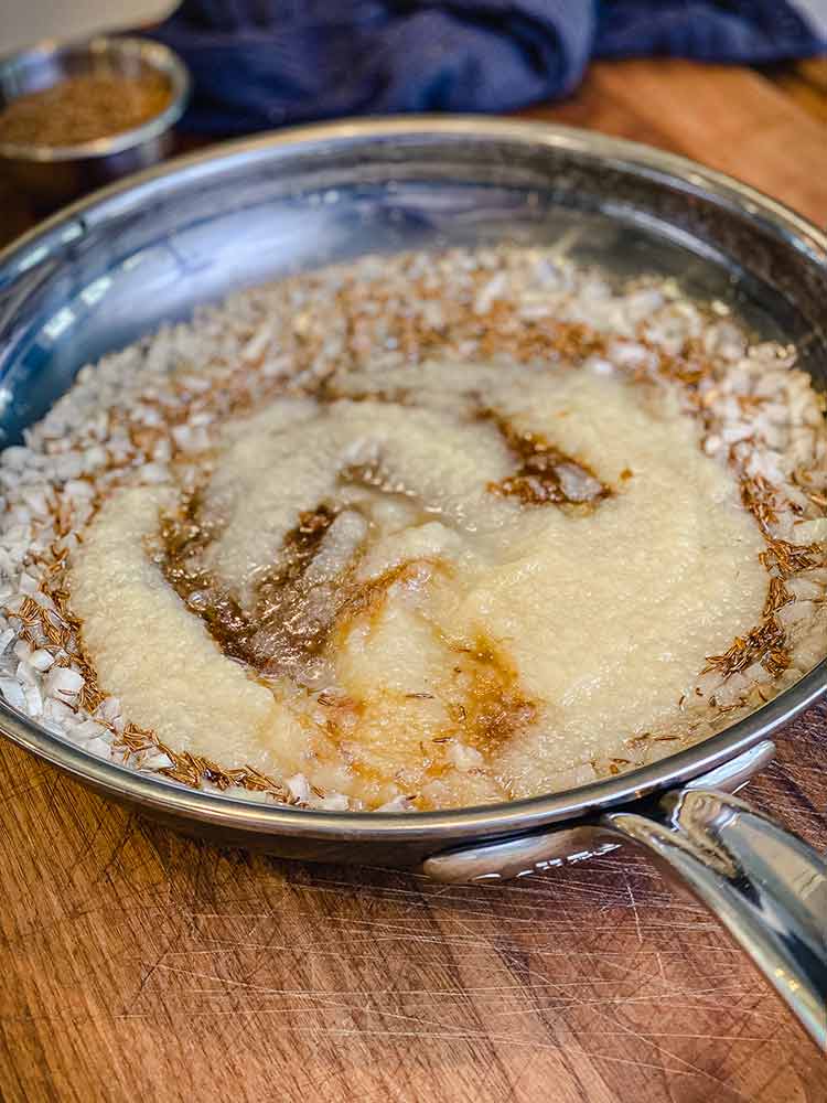 applesauce, brown sugar, pepper and carraway seeds added to the pan of onions