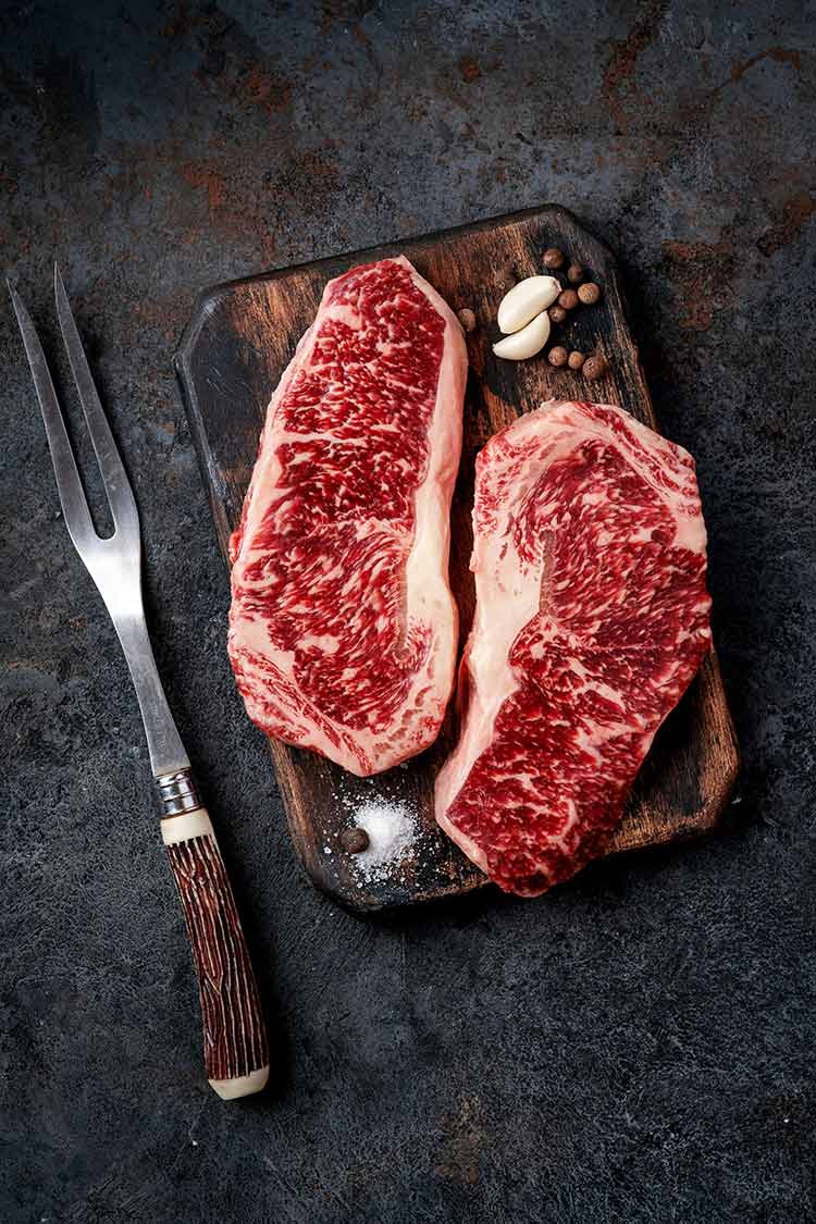 hand-trimmed meat on a cutting board, perfectly marbled and uniform in size