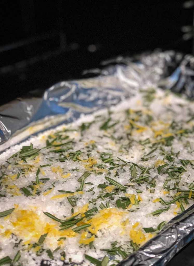 Foil tray with salt, lemon zest and rosemary