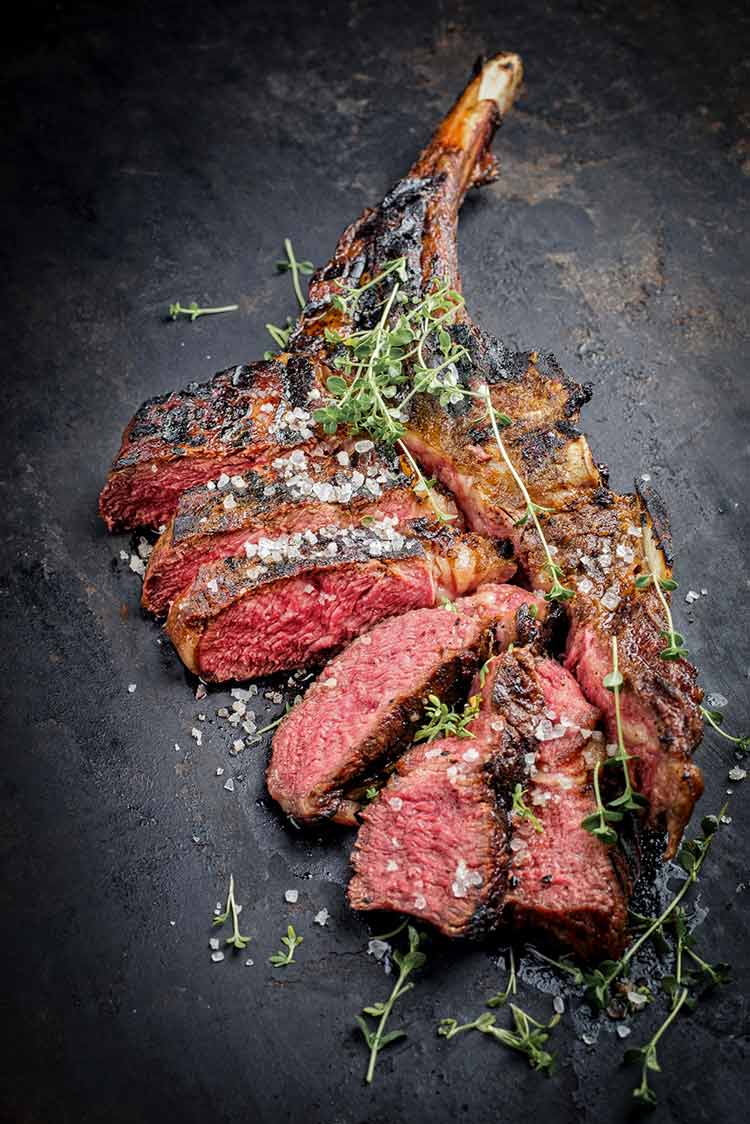 medium rare tomahawk steak, sliced