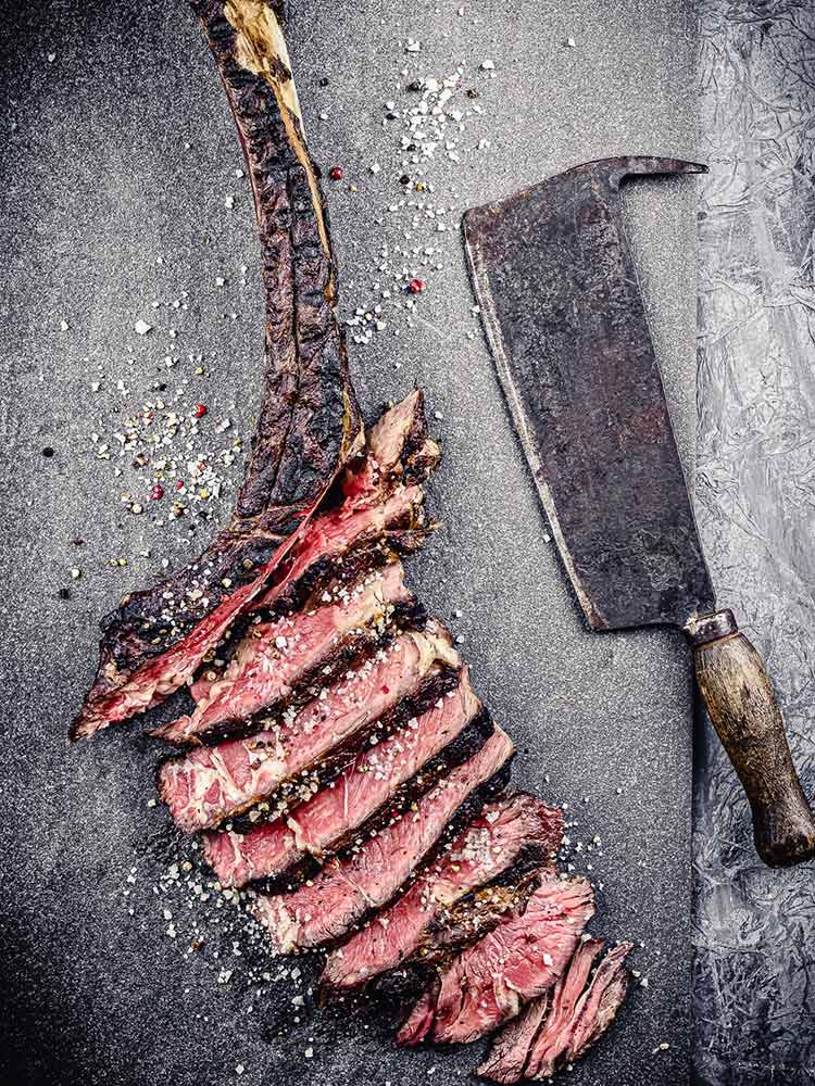 steak and knife on cutting board