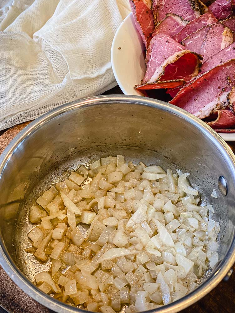 onions doe french dip pastrami sweating in saucepan