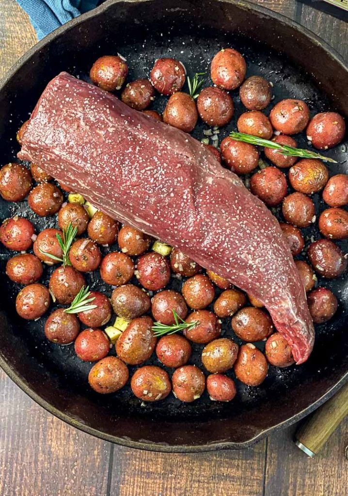 chateaubriand roast salted on bed of potatoes