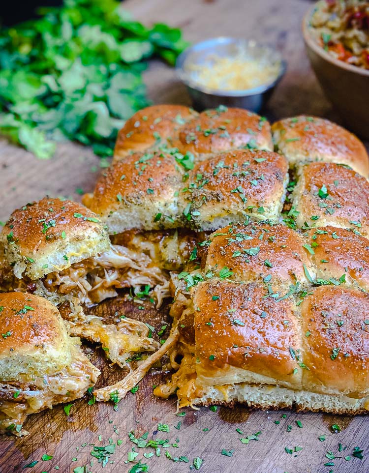 chicken enchilada sliders on cutting board with cheese