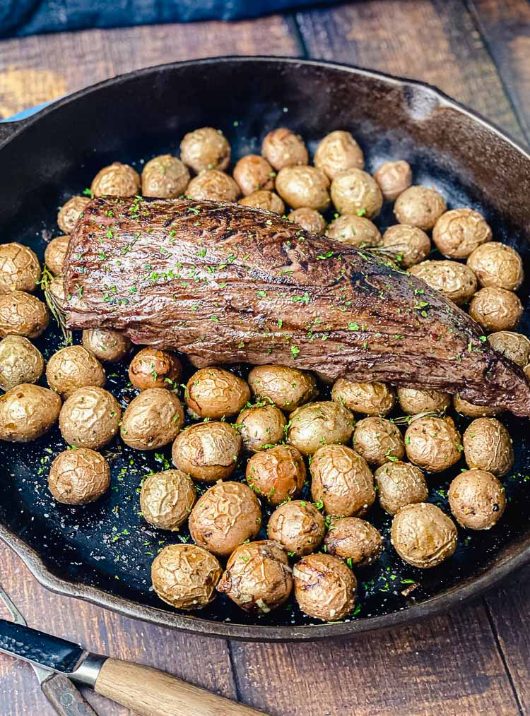 cooked chateaubriand on a bed of potatoes