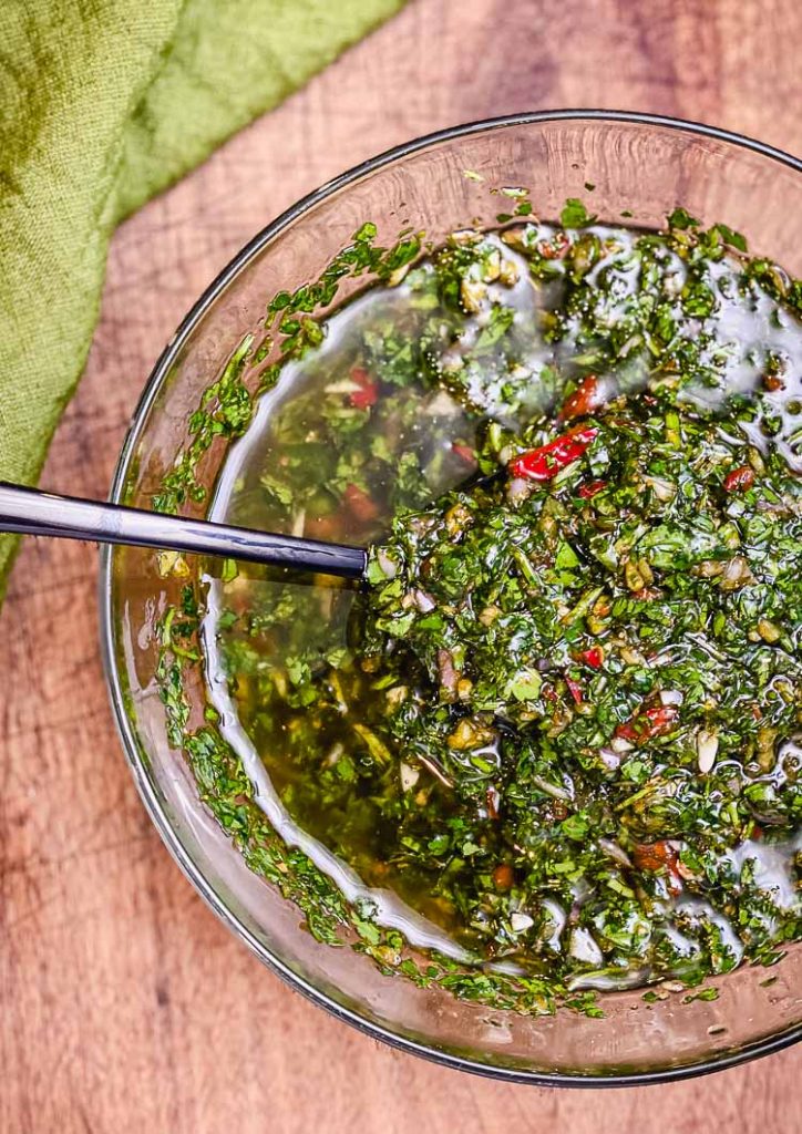 chimichurri in mixing bowl with spoon