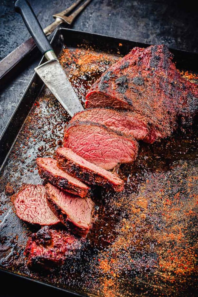 smoked and seared trip tip sliced on a baking sheet