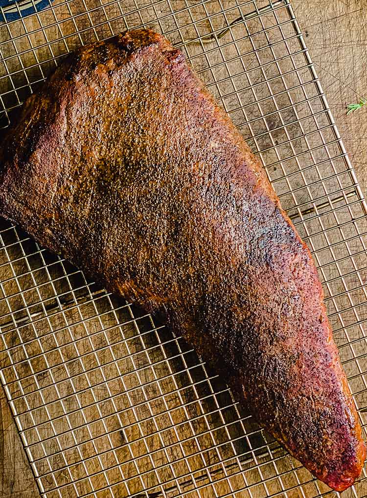 tri-tip roast, cooked perfectly and resting on a cooling rack