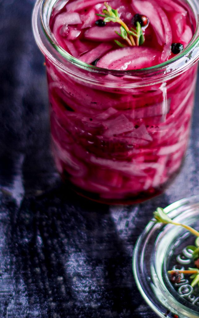 pickled red onion recipe in a glass jar with thyme