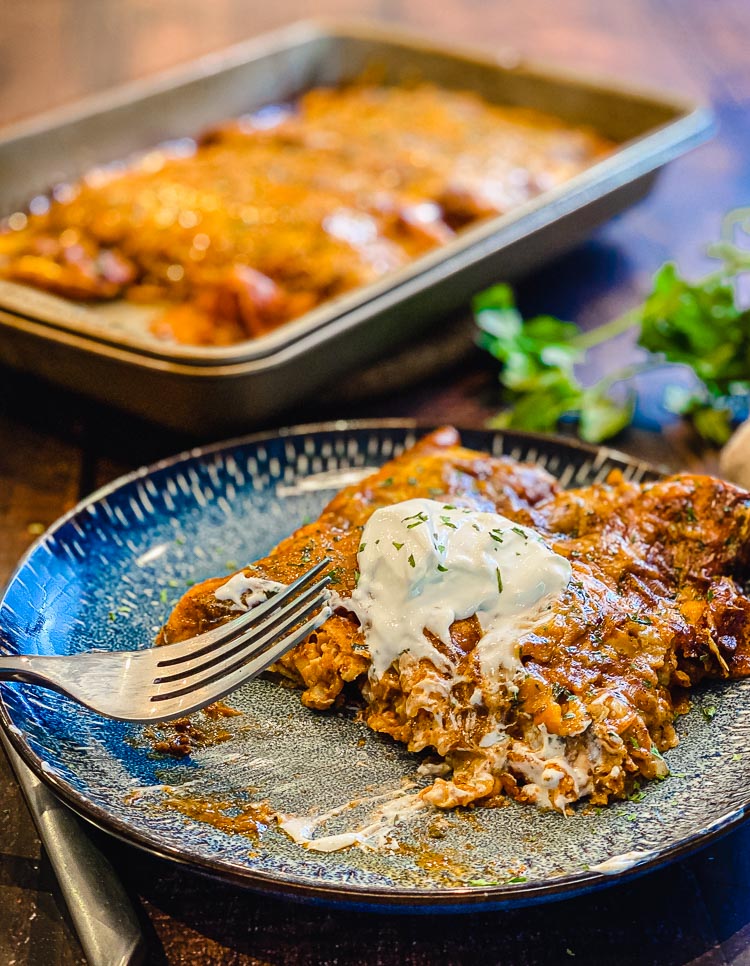 plate with enchiladas and sour cream