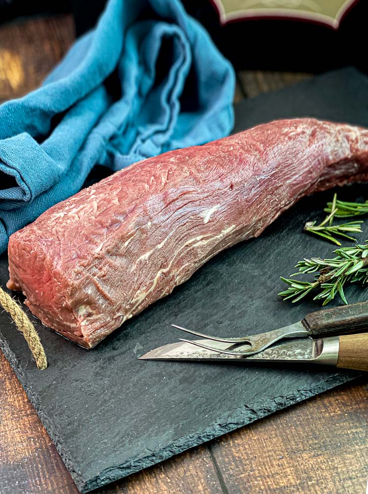 chateaubriand roast uncooked on a cutting board