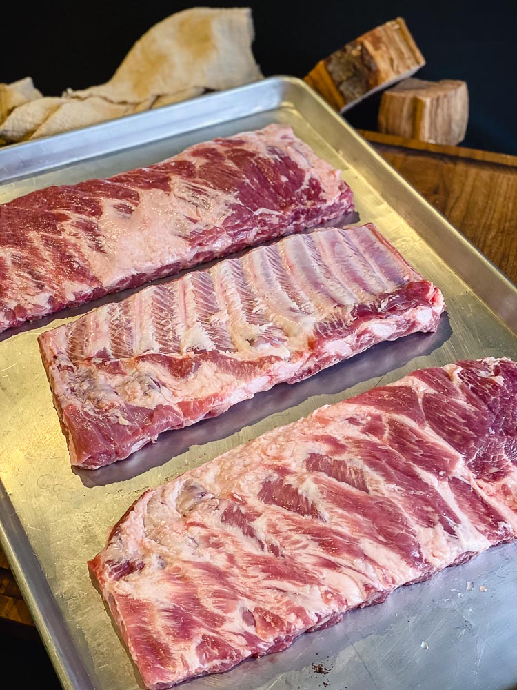 uncooked racks of pork spare ribs