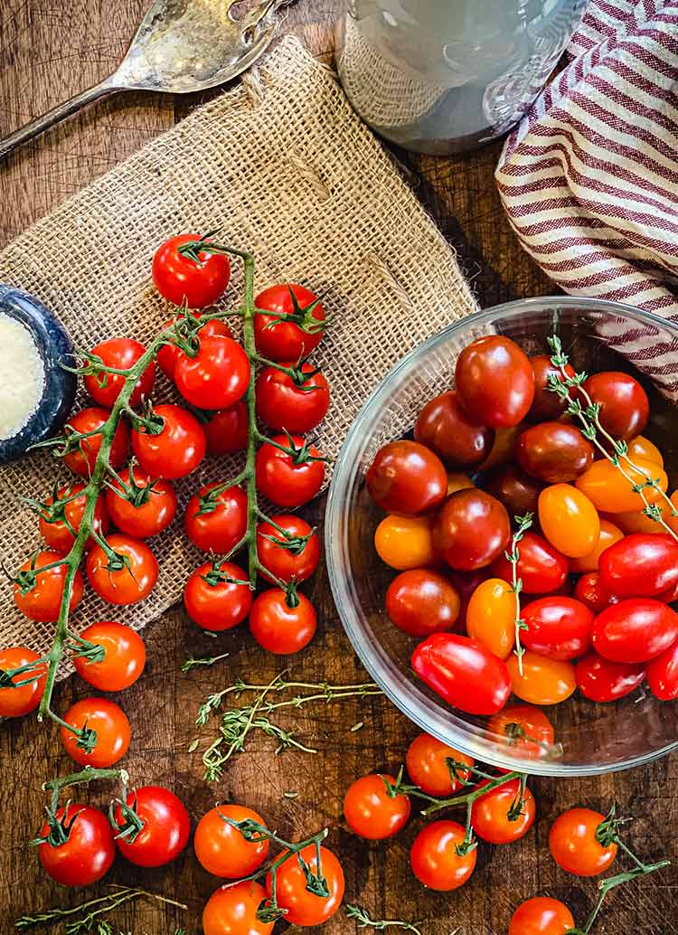 cherry tomatoes on a vine, grape tomatoes in a bowl