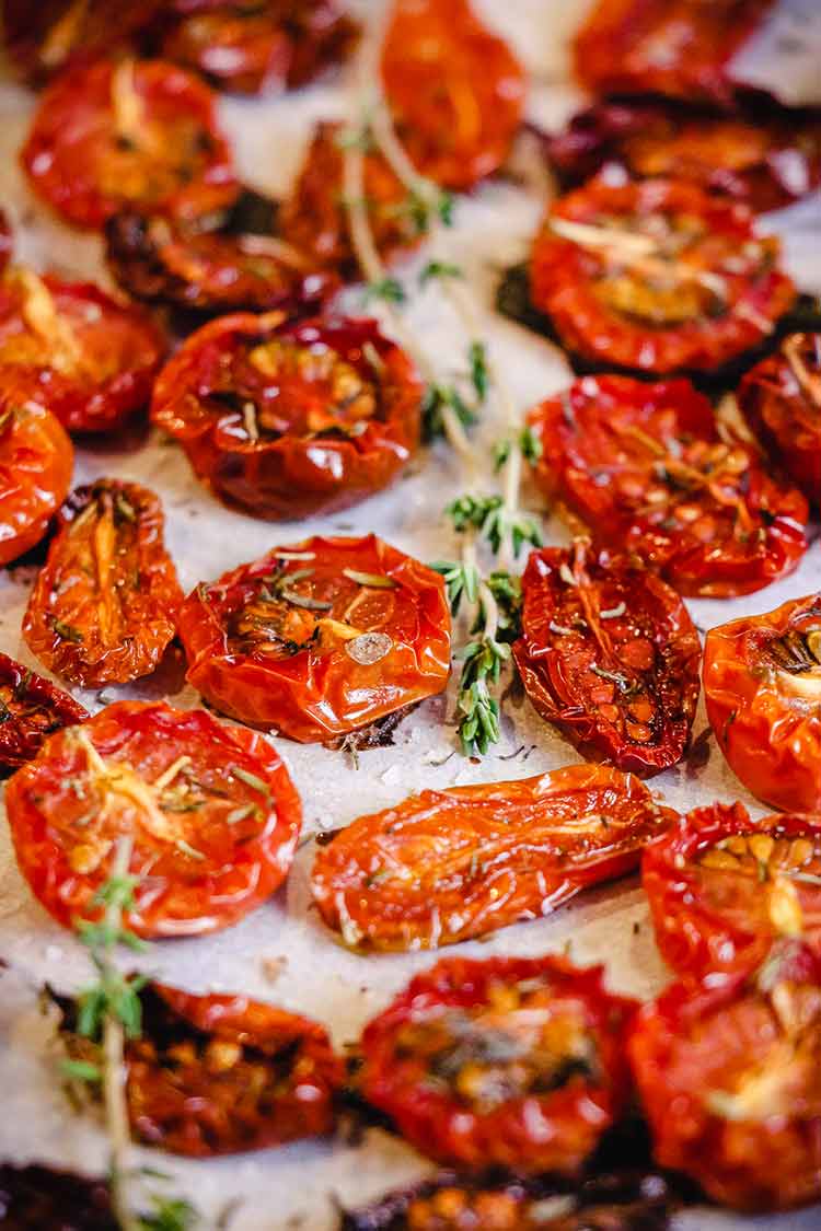 roasted cherry tomatoes on pan lined with parchment paper