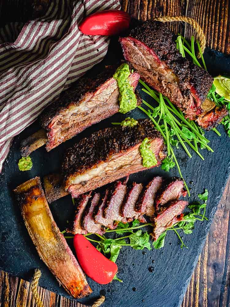 sliced beef ribs on slate platter