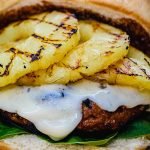 Turkey burger loaded with pineapple, teriyaki sauce and cheese