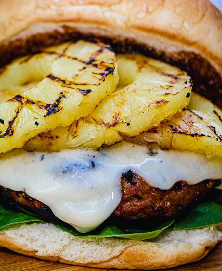 Turkey burger loaded with pineapple, teriyaki sauce and cheese