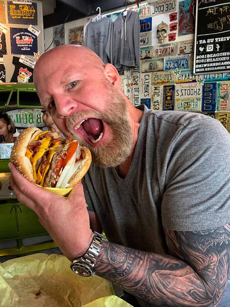 Matthew Eads with triple bacon cheeseburger