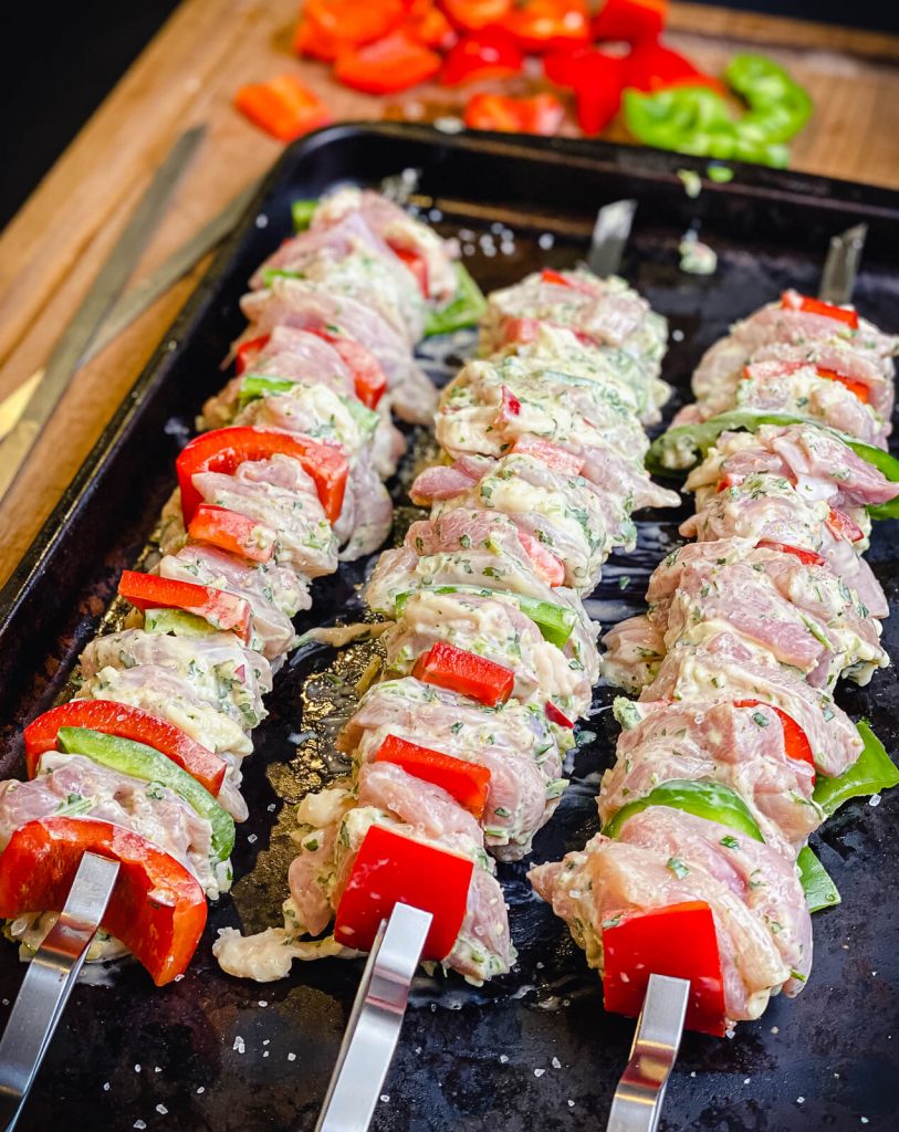 uncooked assembled chicken kabobs on a tray