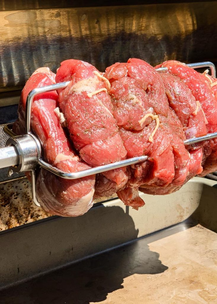 boneless leg of lamb on a rotisserie spit