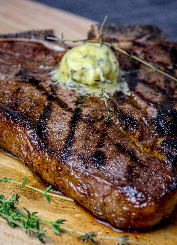 compound butter for steak melting on a porterhouse steak