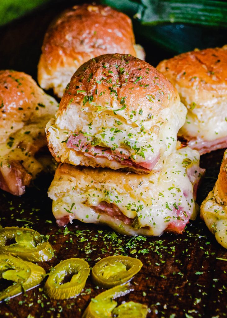 ham and cheese sliders on cutting board