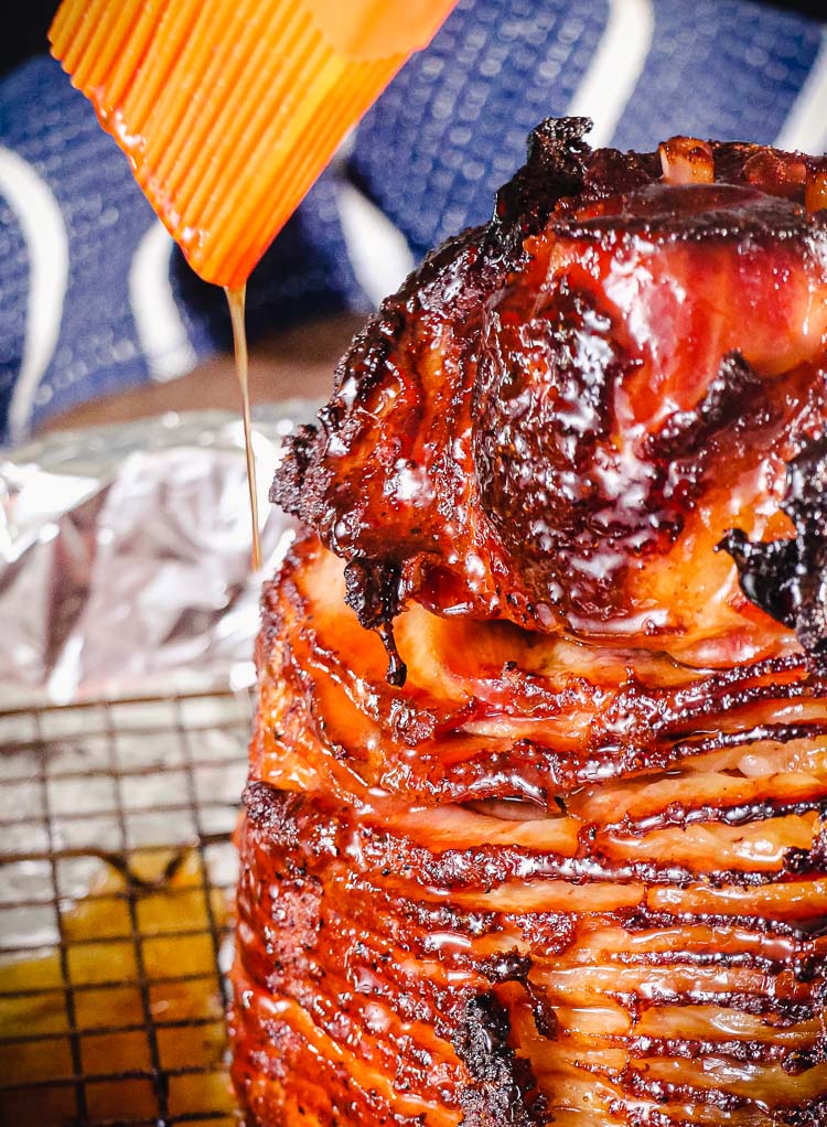 glaze being dripped onto spiral cut ham