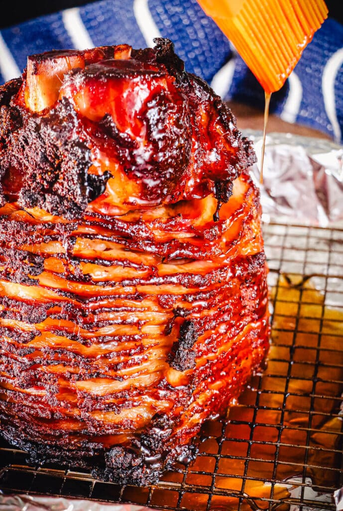 Ham glaze being drizzled over a spiral cut ham