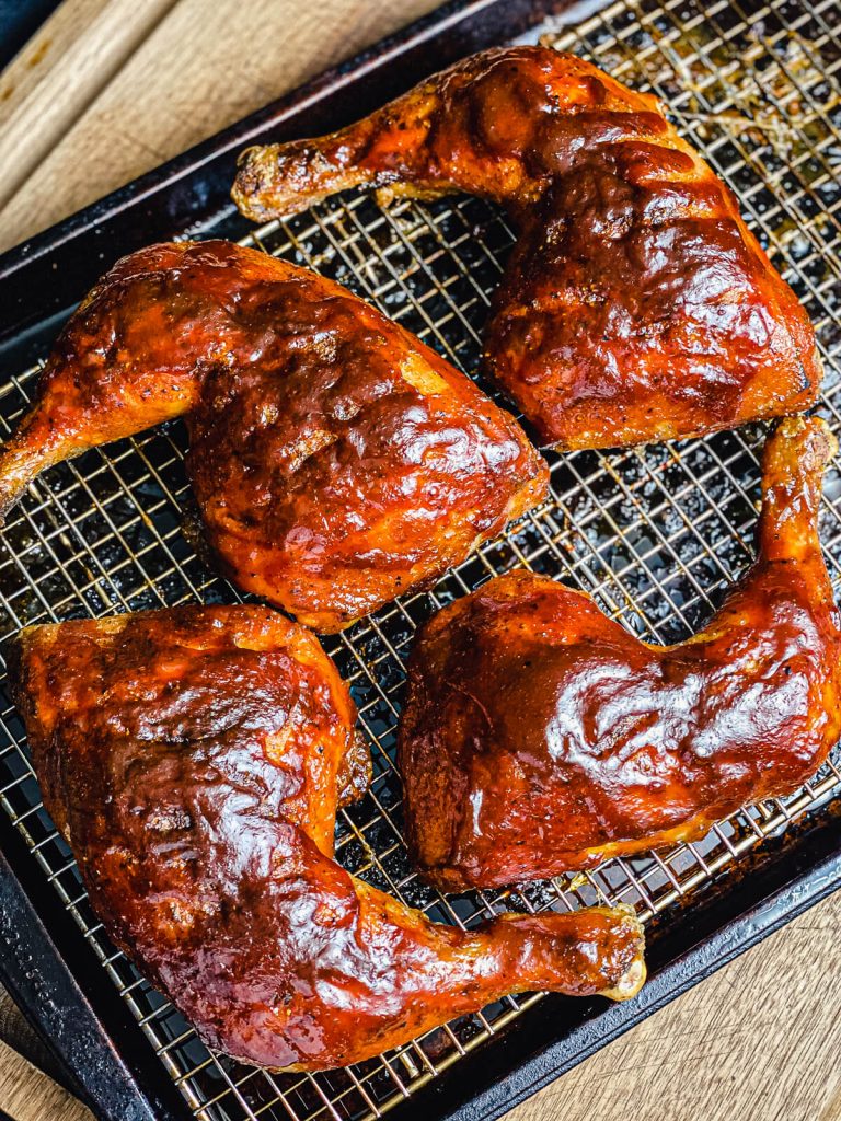 grilled chicken quarters with bbq sauce on them
