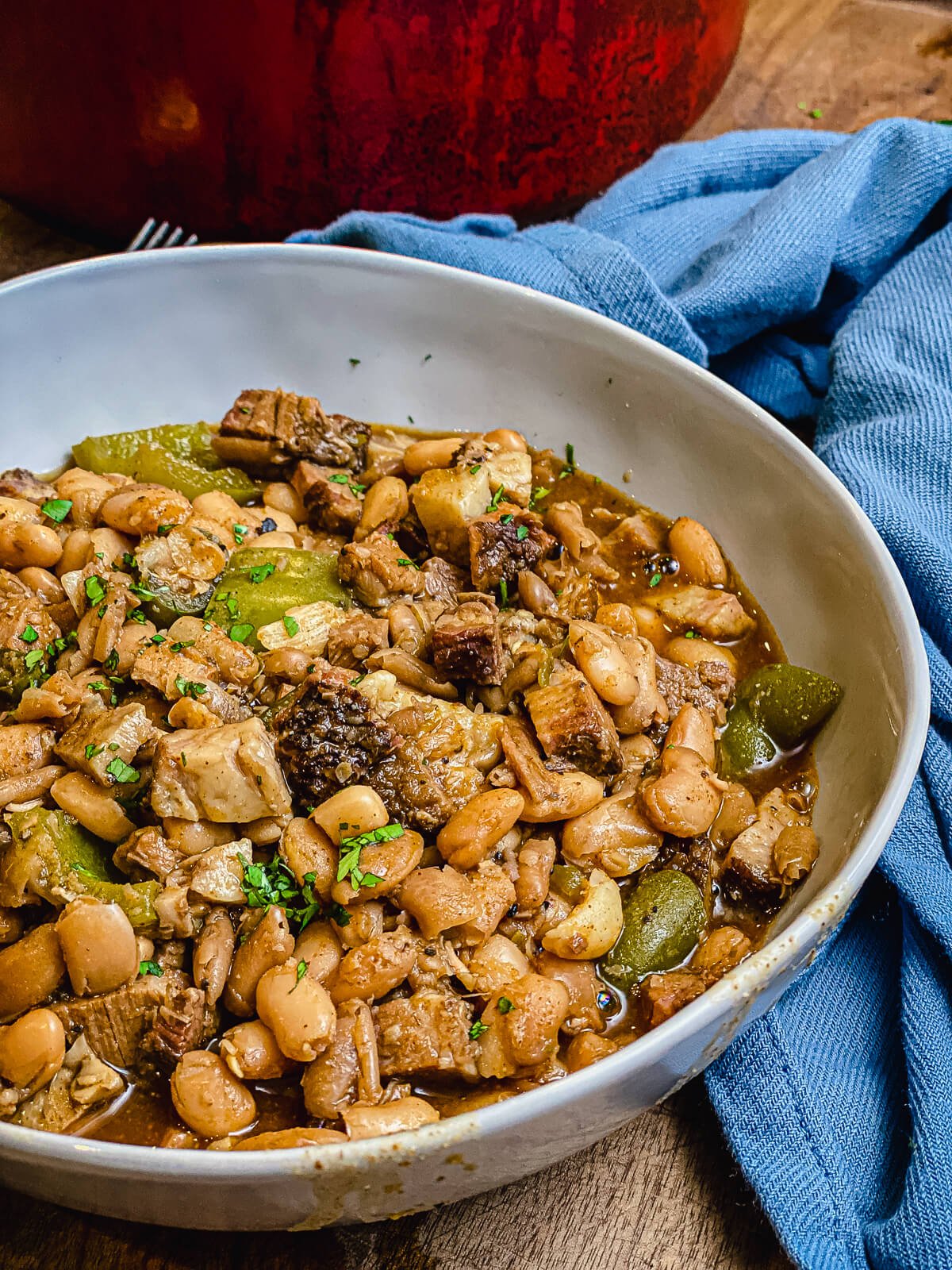 bowl of pinto beans with peppers and a blue napkin