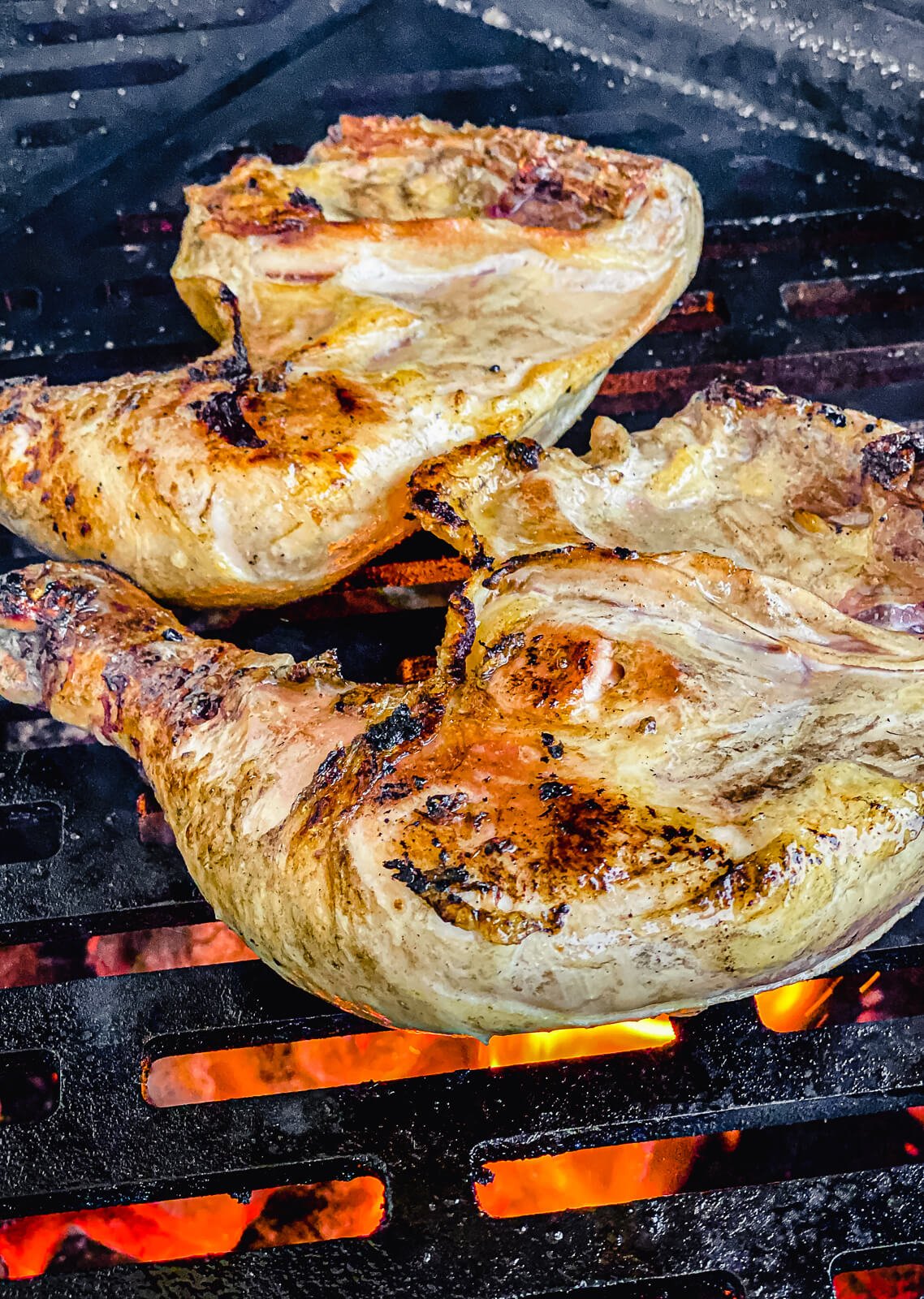 grilled chicken quarters on the grill skin side down