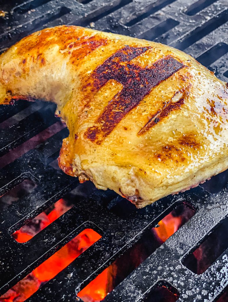 grilled chicken quarter on the grill