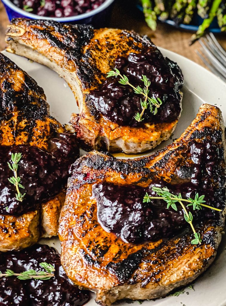 blueberry chipotle sauce on top of grilled pork chops
