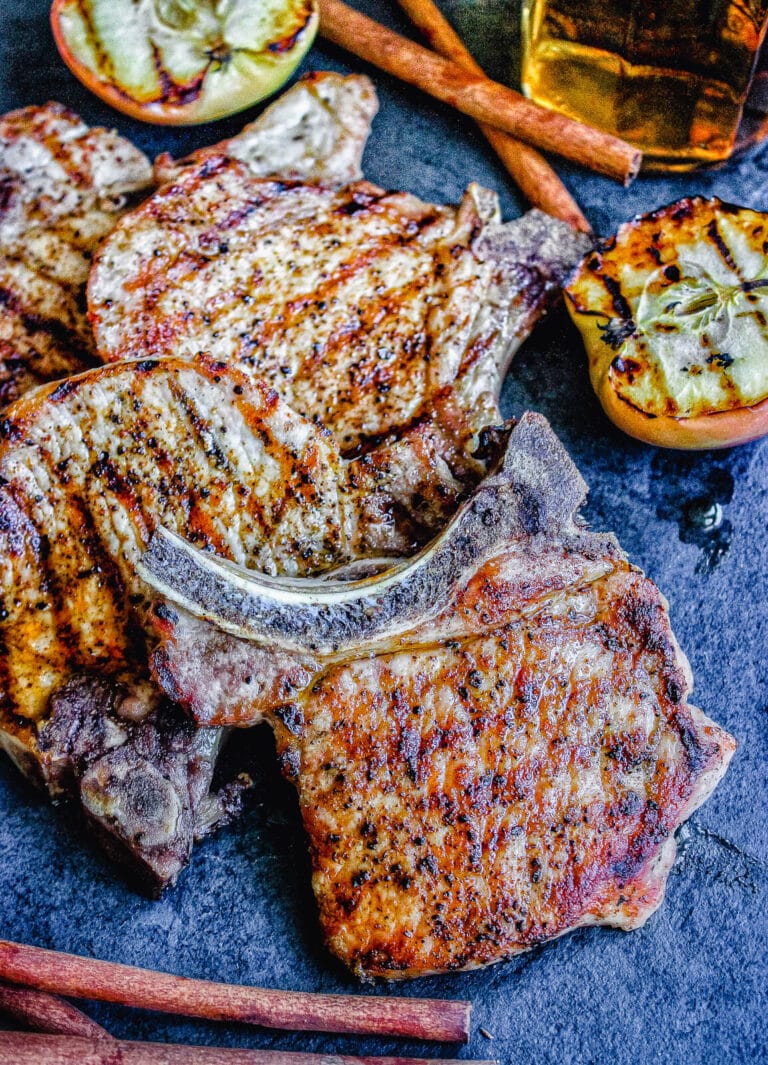 grilled glazed pork chops on a cutting board