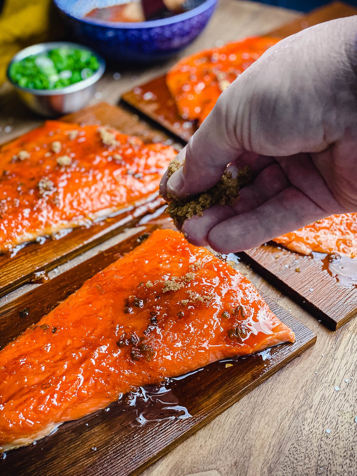 brown sugar being added to cedar plank salmon