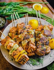 citrus and dill salmon kabobs on a plate