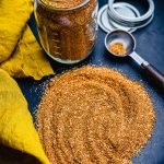 homemade bbq rub in a glass jar on a slate board