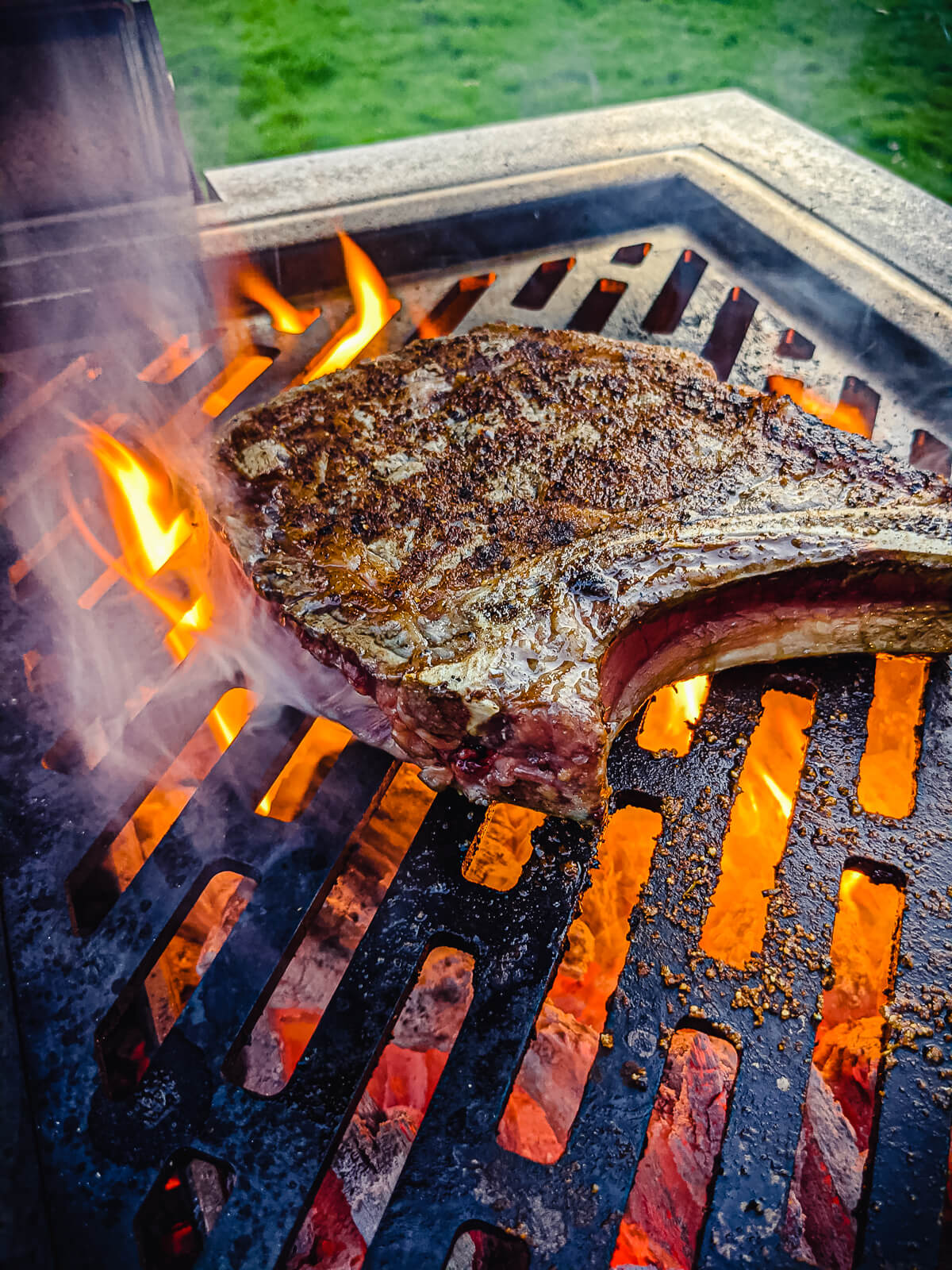 ribeye steak on the grill over fire