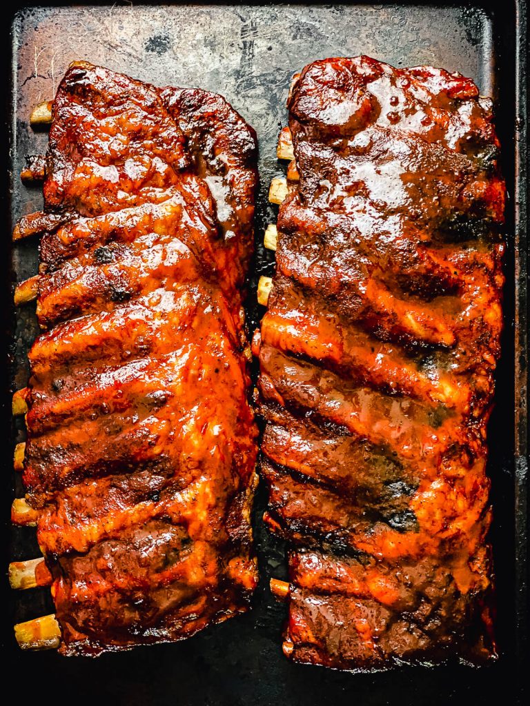 two racks of spare ribs on a platter