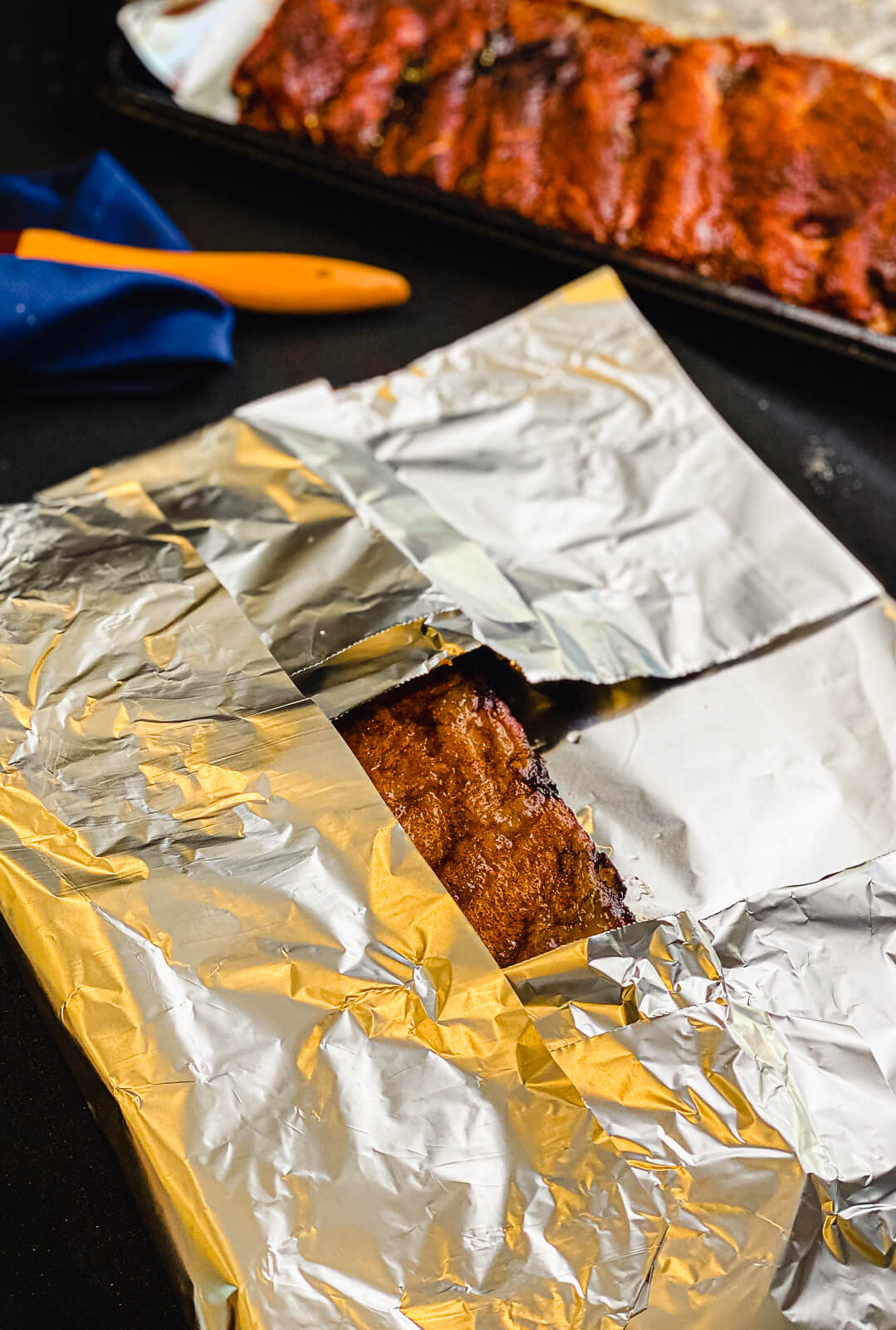 pork ribs being wrapped in foil