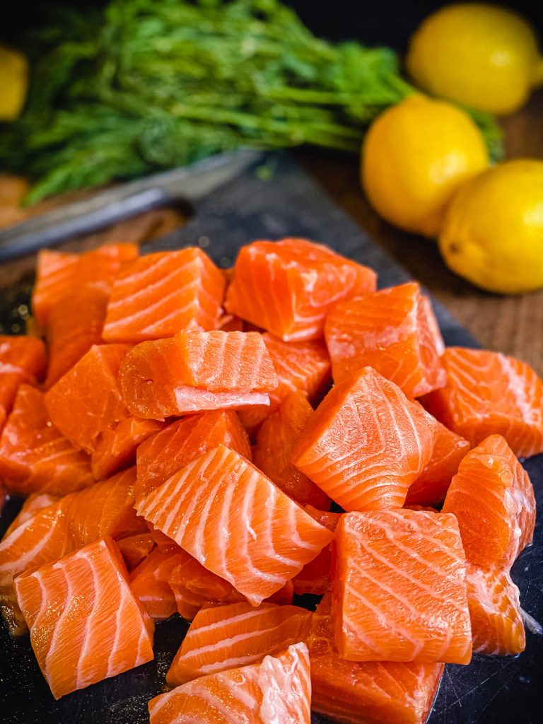 salmon cut into cubes with lemons