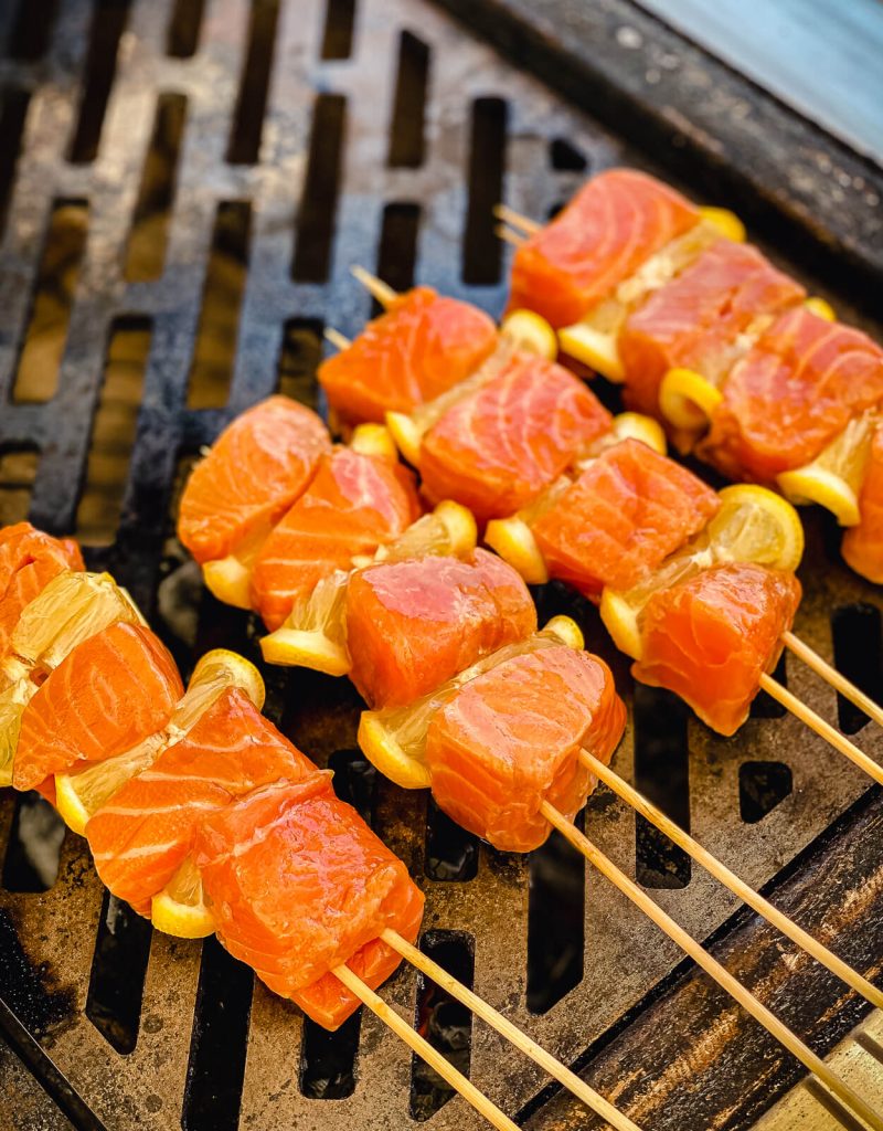 salmon kabobs on the grill over charcoal