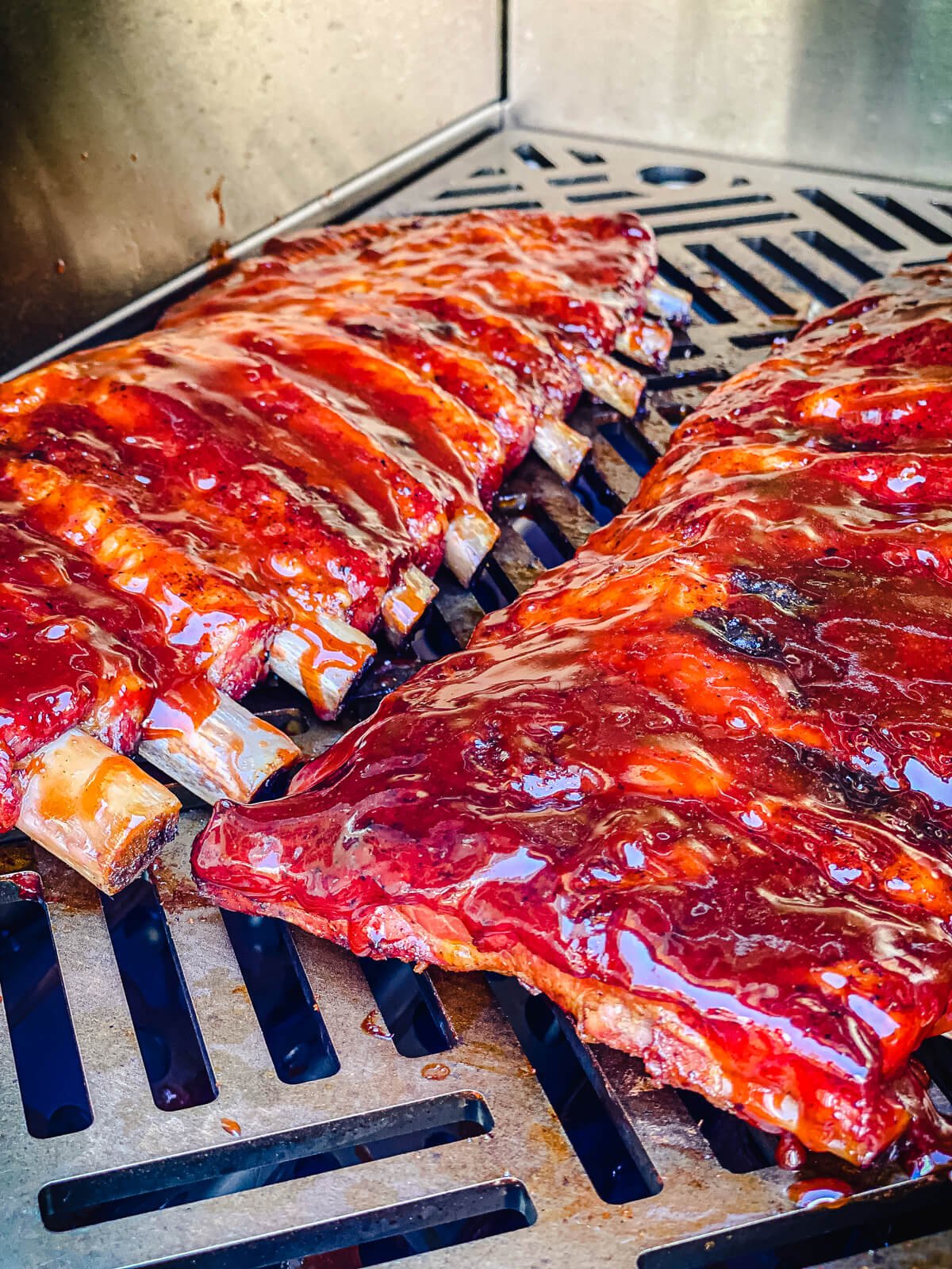 sauced bbq ribs on a gas grill