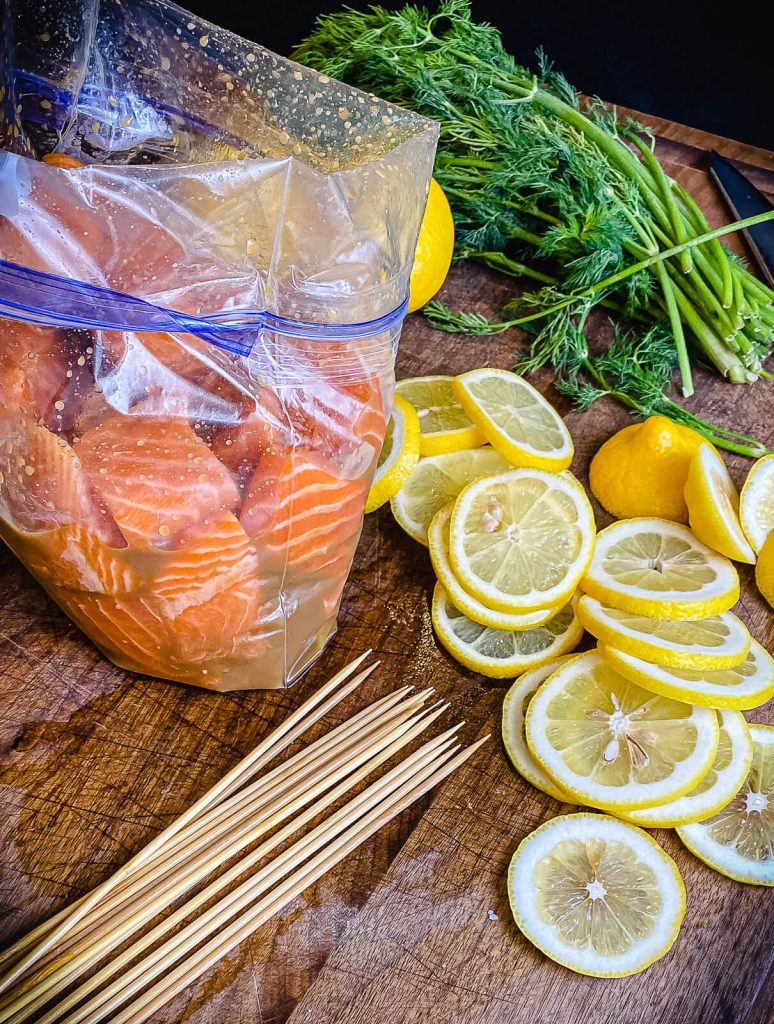 round skewers next to salmon pieces for salmon kabobs