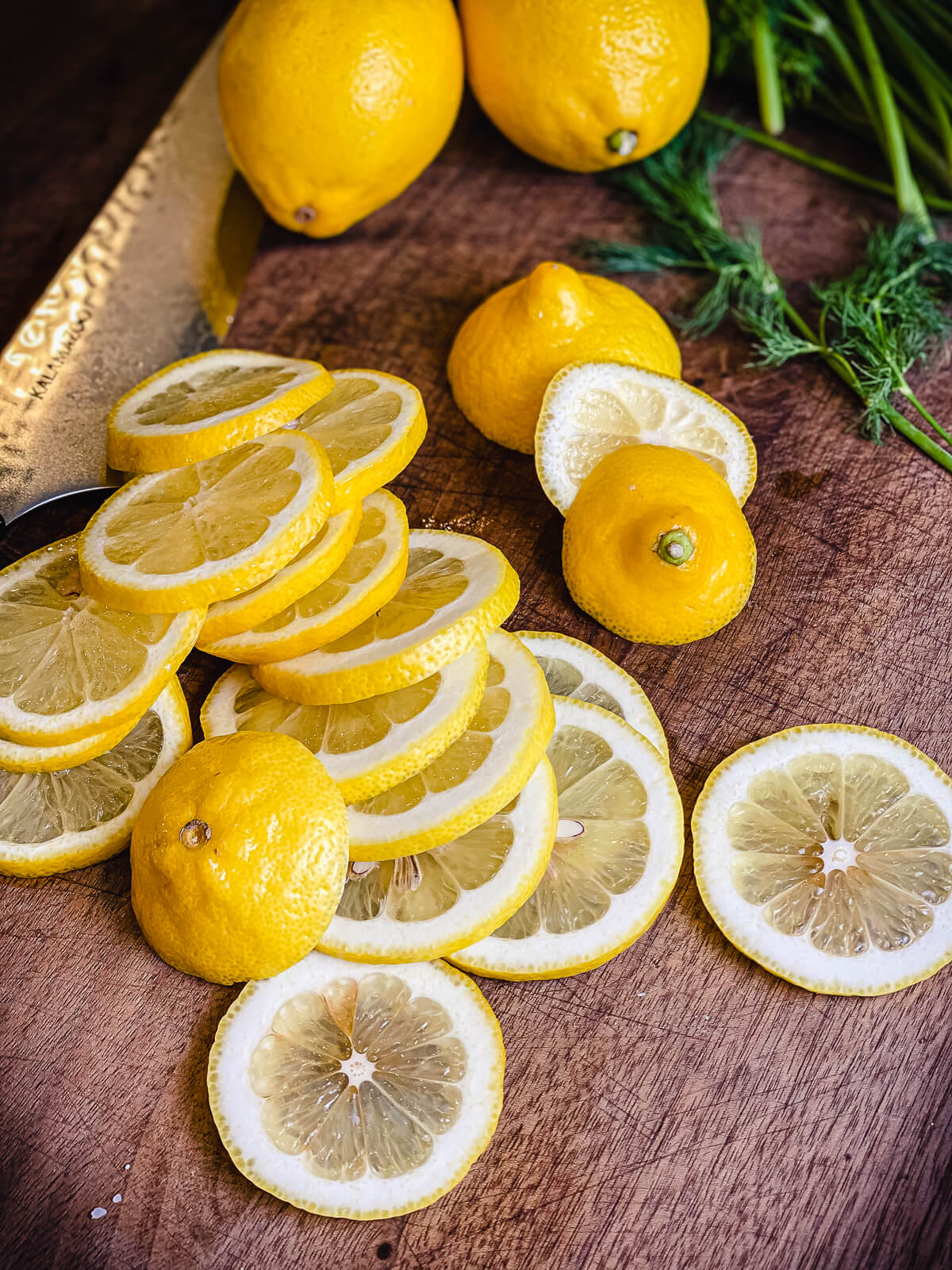 pile of sliced lemons on a cutting board