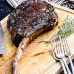 tomahawk ribeye on a wood cutting board